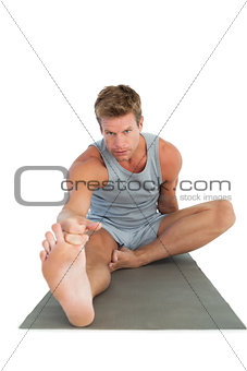 Man stretching his leg on the floor