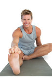 Cheerful man working out on the floor