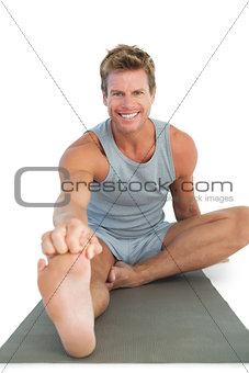 Cheerful man working out on the floor