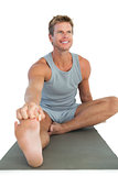 Man working out and stretching his leg