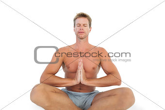 Man doing yoga and meditating on the floor