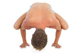 Man doing a crane pose during a yoga session