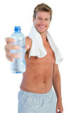 Shirtless handsome man offering water