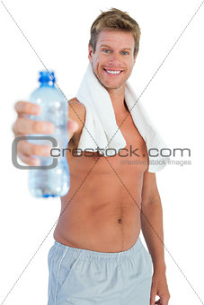 Shirtless handsome man offering water