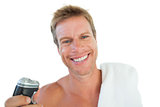 Cheerful man holding an electric razor
