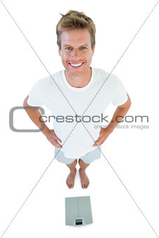 Man standing in front of weighing scale