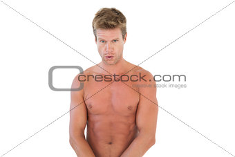 Handsome shirtless man showing his muscles