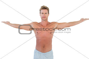 Shirtless man opening his arms