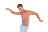 Shirtless man gesturing and showing his muscles