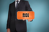 Businessman selecting orange tag with roi