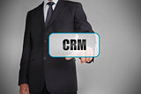 Businessman selecting tag with crm written on it