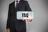 Businessman selecting tag with faq written on it