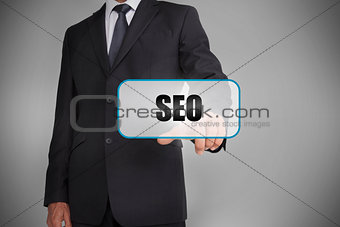 Businessman selecting tag with seo written on it