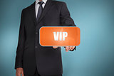 Businessman selecting orange tag with the word vip written on it