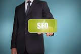 Businessman touching green tag with the word seo written on it