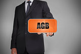 Businessman touching orange tag with the word agb written on it