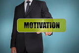 Businessman touching the word motivation written on green tag