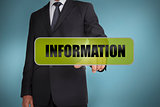 Businessman touching the word information written on green tag
