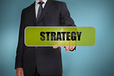 Businessman touching the word strategy written on green tag