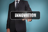 Businessman touching the word innovation written on black tag