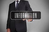 Businessman selecting the word information written on black tag
