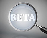 Magnifying glass showing beta word in white
