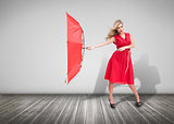 Pretty glamour woman holding a broken umbrella