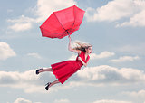 Attractive woman flying in the blue sky