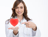 Doctor holding and pointing at a red heart
