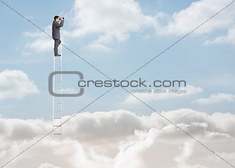 Businessman standing on a ladder over the clouds