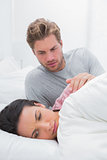 Upset woman ignoring her partner in her bed