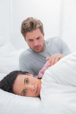 Woman ignoring her partner in her bed