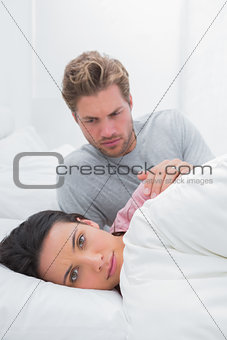 Woman ignoring her partner in her bed