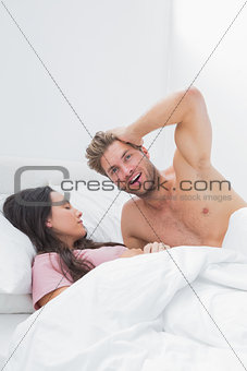 Handsome man posing next to his sleeping partner