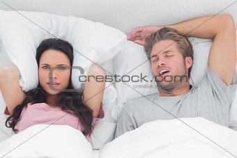 Woman annoyed by the snoring of her husband