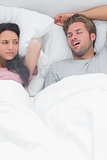 Brunette annoyed by the snoring of her husband