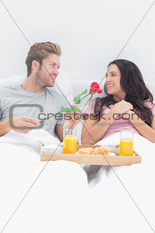 Handsome man giving a rose to his wife