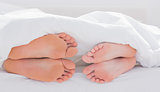 Feet of partners under the quilt