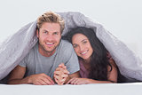 Cheerful couple under the cover