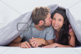 Handsome man kissing his wife