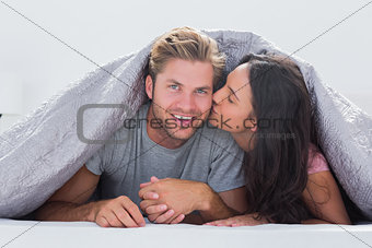 Woman kissing her husband