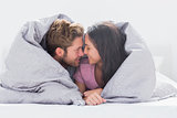 Couple wrapped in the duvet