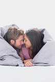 Beautiful couple wrapped in the duvet