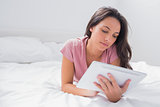Woman using a tablet in her bed