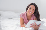 Woman using a tablet pc in her bed