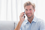 Man smiling while he is on the phone