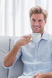 Cheerful man drinking a coffee