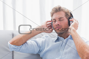 Man listening to music on a couch