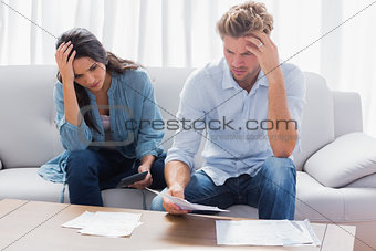 Desperate couple doing their accounts