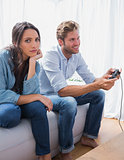 Sad woman annoyed that her partner is playing video games